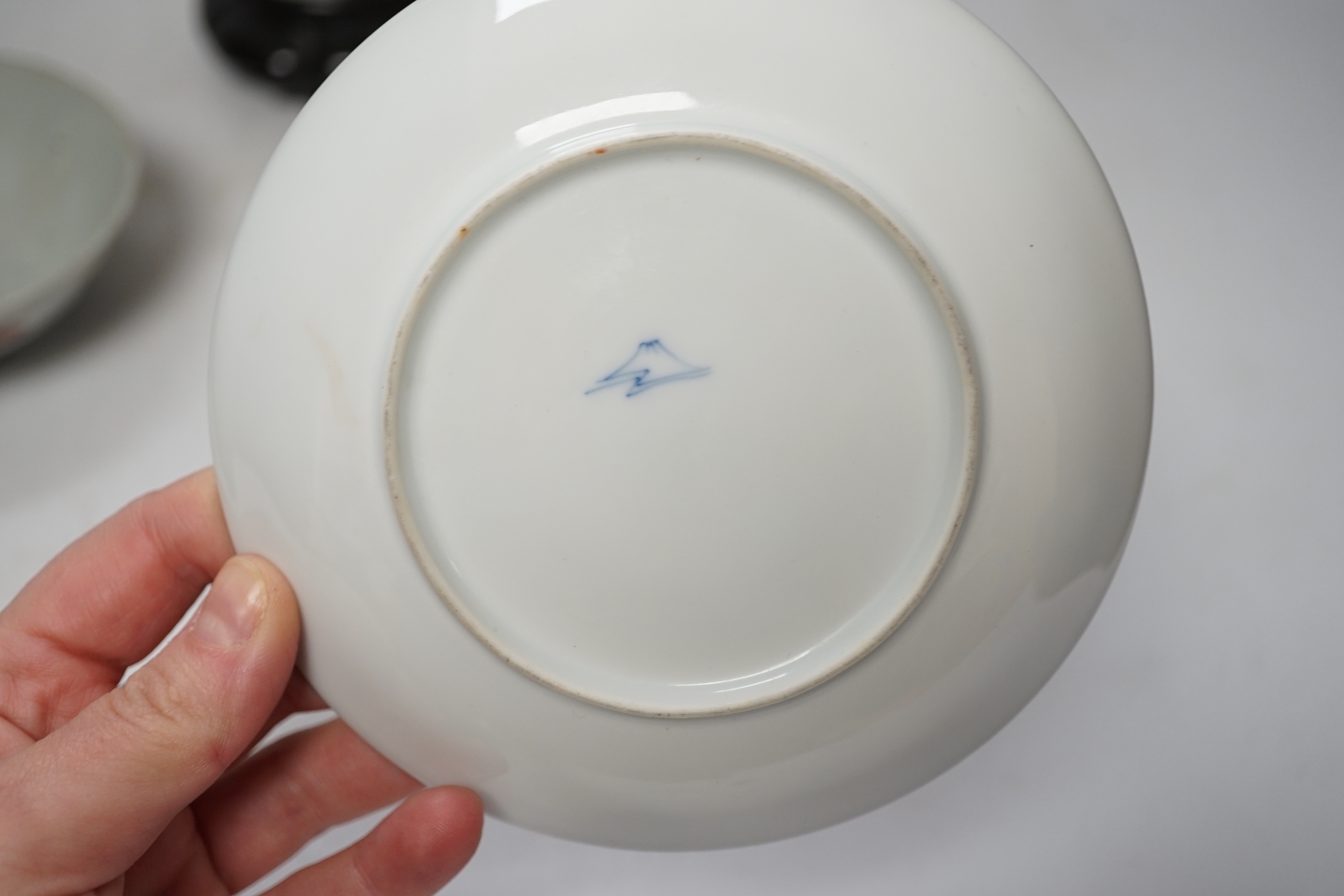 A Chinese famille rose vase, a rice dish, saucer and wooden stands